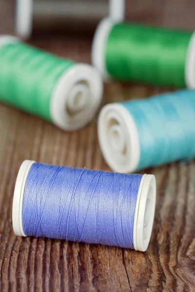 Spools of thread on wooden background — Stock Photo, Image