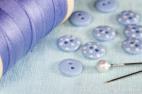 Buttons, thread and pins on fabric — Stock Photo, Image