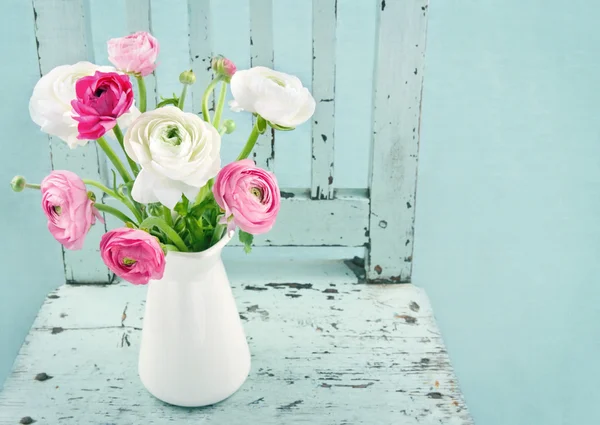 White and pink flowers on light blue chair — Stock Photo, Image