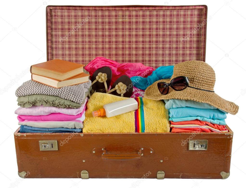 Old vintage suitcase packed with clothes