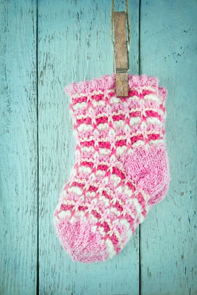 Pink baby socks on a blue background — Stock Photo, Image
