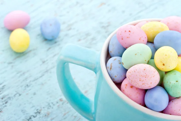 Kleine pastellfarbene Ostereier in einer blauen Tasse — Stockfoto