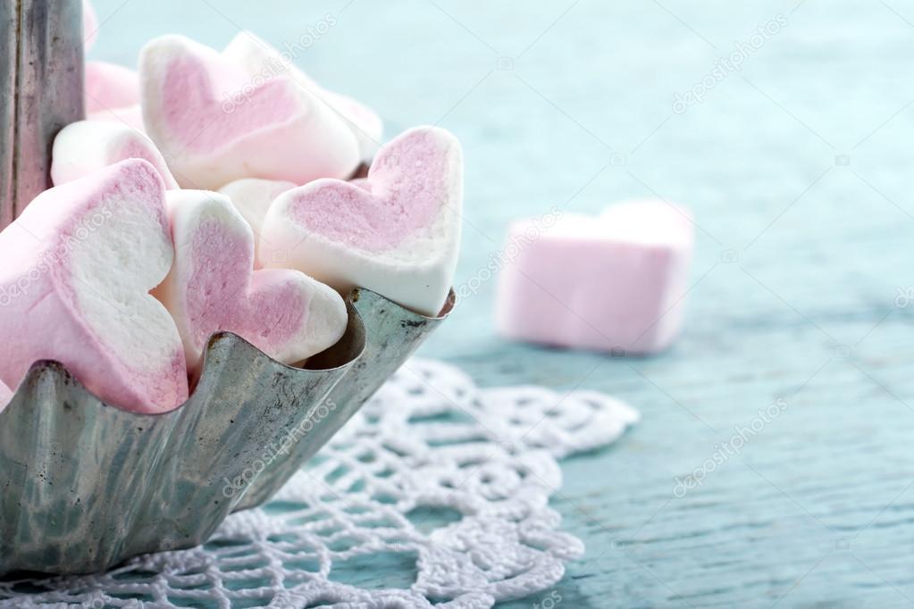 Pink heart-shaped marshmallows in with pink background Stock Photo