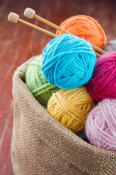 Woolen balls of yarn in a rustic craft bag — Stock Photo, Image