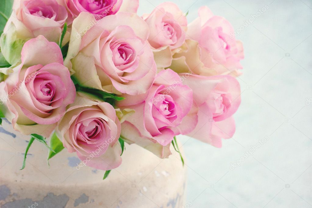 Pink roses in a shabby chic metal bucket