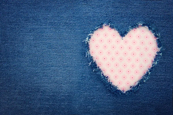 Blue denim jeans with pink heart — Stock Photo, Image