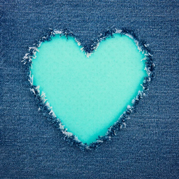 Turquoise vintage heart on blue denim fabric — Stock Photo, Image