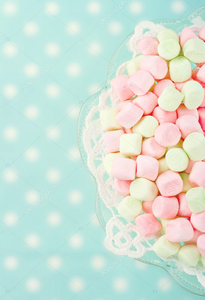 Pink marshmallows on blue background