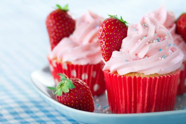 Cupcakes with strawberries and colorful sprinkles clipart