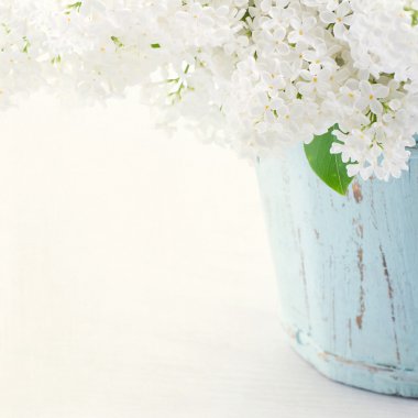 Lilacs in a wooden blue vase