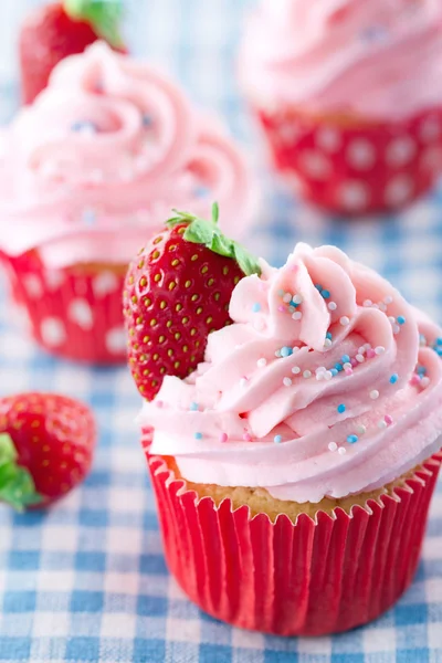 Strawberry cupcakes on vintage blue towel — Stock Photo, Image