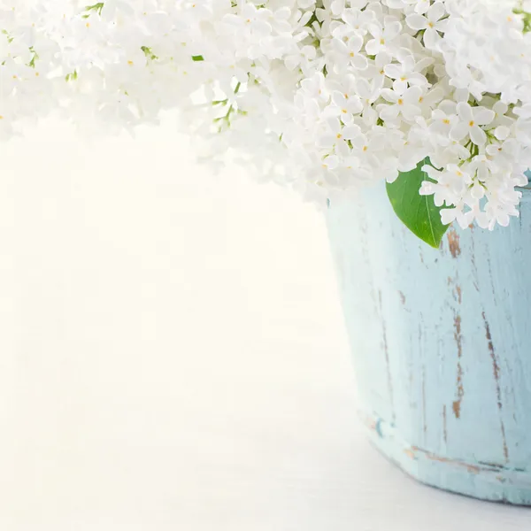 Lilacs in a wooden blue vase — Stock Photo, Image