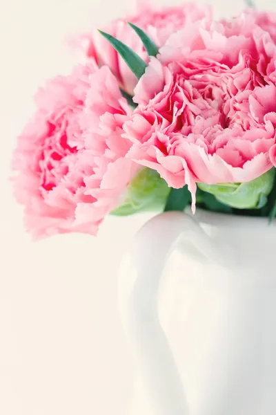 Pink carnations on light shabby chic background — Stock Photo, Image