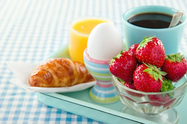 Breakfast on blue table cloth — Stock Photo, Image