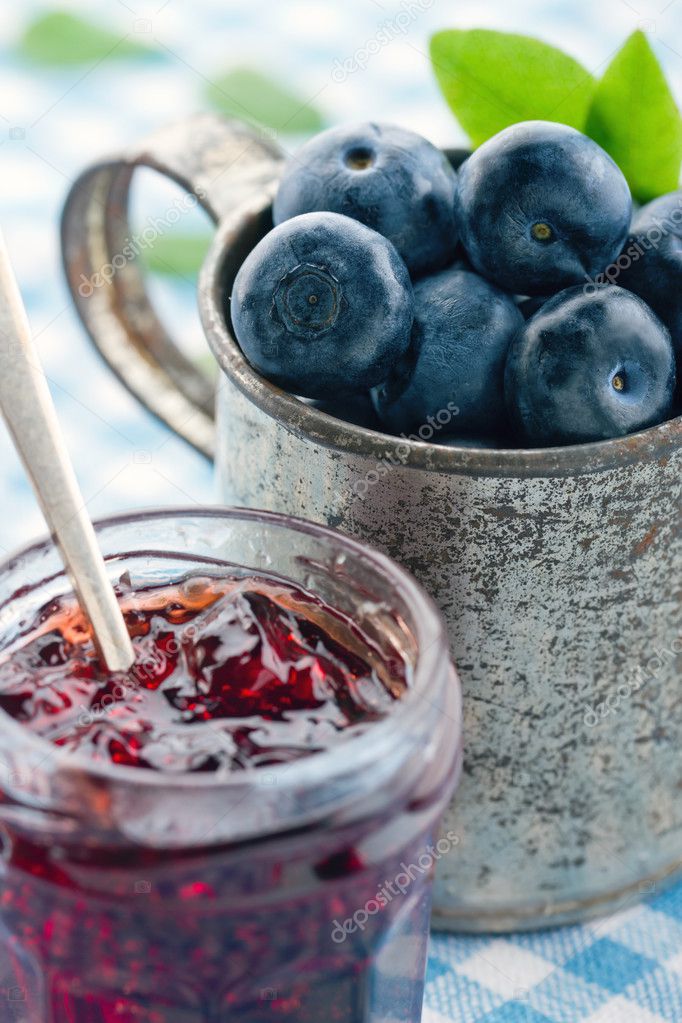 Old metal cup with fresh blueberries