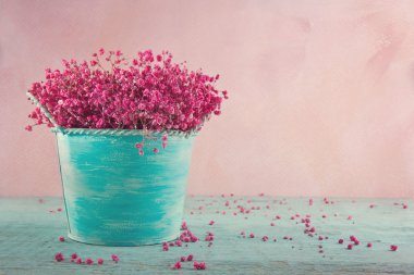 Pink baby's breath flowers on wooden background clipart