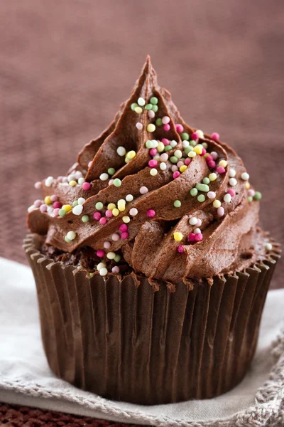 Un seul cupcake au chocolat avec des saupoudres — Photo