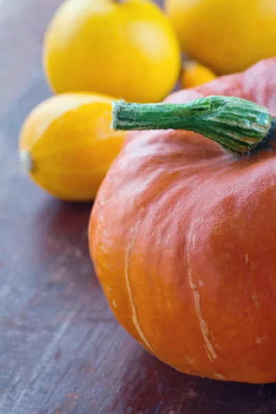 Pumpkins on red wooden rustic background — Stock Photo, Image