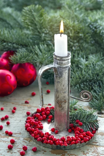 Old metal candlestick with white burning candle — Stock Photo, Image