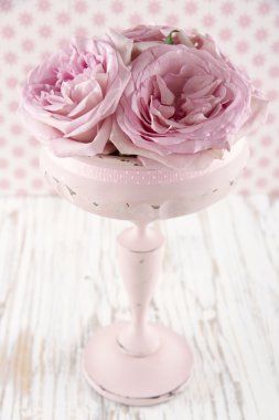 Pink roses in a wooden pastel color vase clipart