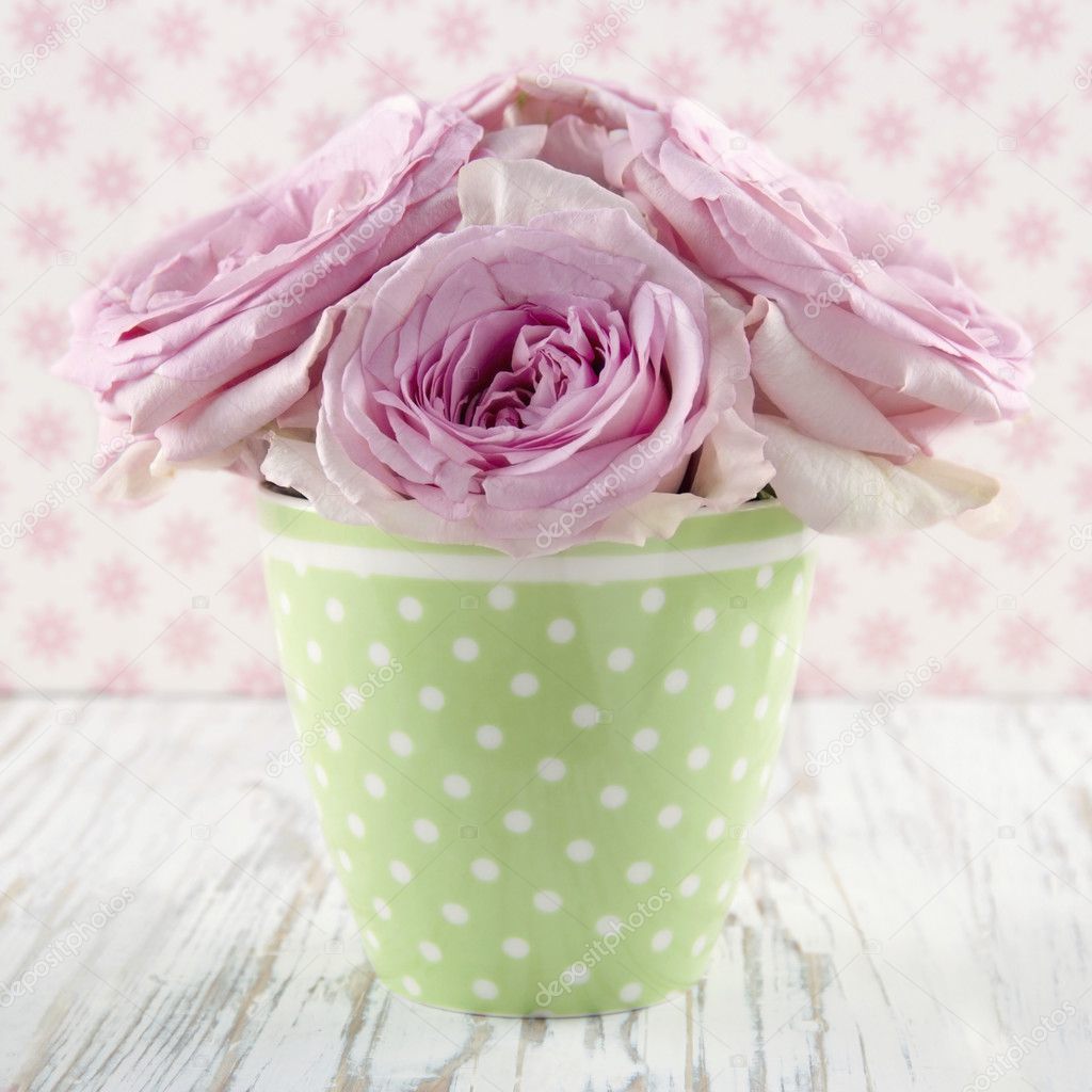 Pink flowers in a green polkadot vase