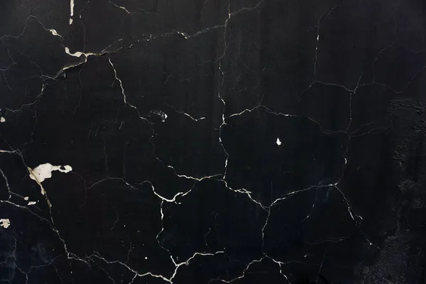 Black background with cracked surface. Cracks in the shape of a web. Cement base texture. — Stock Photo, Image