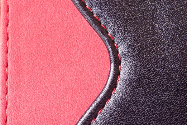 Part of a product made of red fabric with a leather insert — Stock Photo, Image