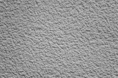 Part of a gray rough uneven concrete wall