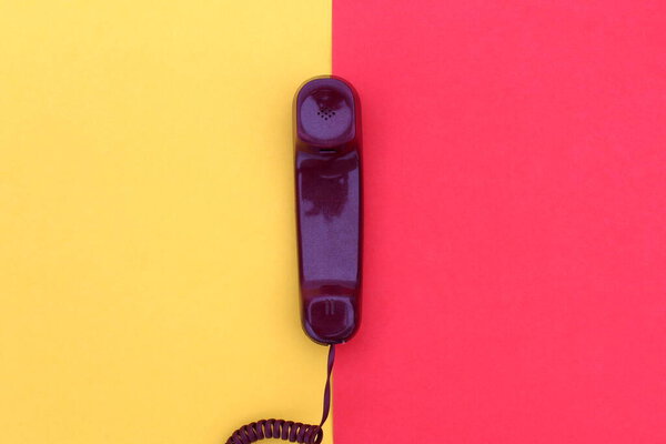 The handset lies on yellow and red colors.