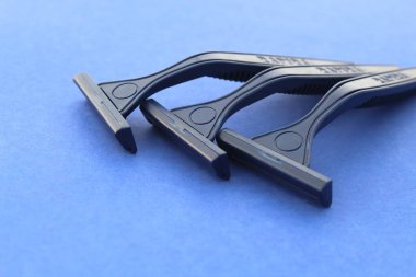 Mavi arka planda üç mavi tıraş bıçağı var..