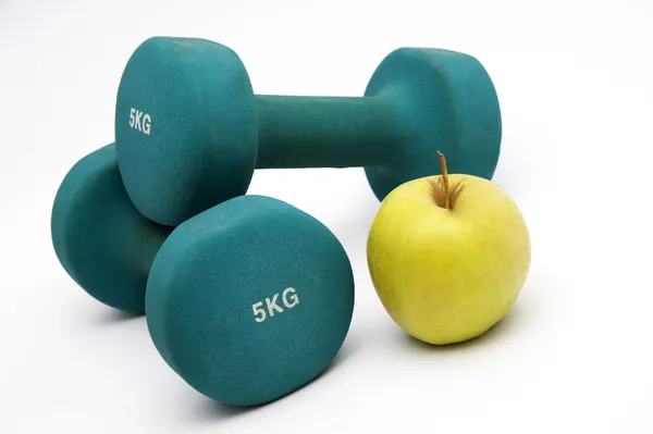 Dumbbells, apple and measure tape — Stock Photo, Image