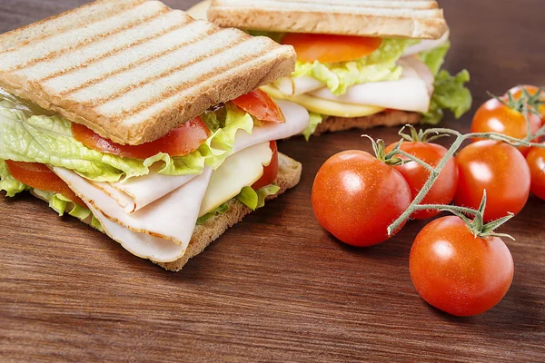 Sandwiches on wooden table — Stock Photo, Image