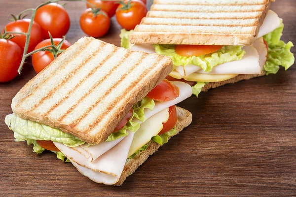 Sandwiches on wooden table — Stock Photo, Image