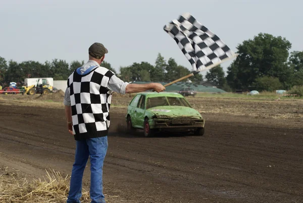 Man with flag on racetrack — Stock Photo, Image