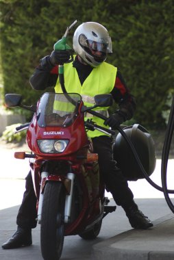 Biker at petrol station clipart