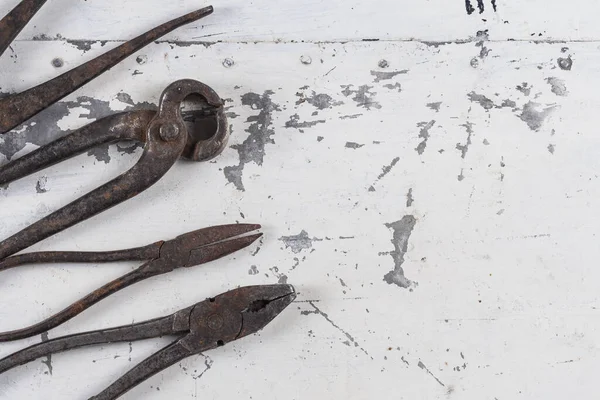 Old rusty construction tools on a gray iron background