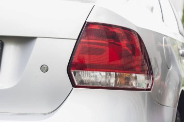 Rear lights of red color on a passenger car close-up