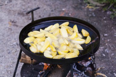 Cooking potatoes on the grill on a close-up, cooking food on a fire