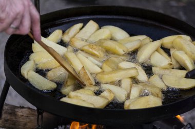 Cooking potatoes on the grill on a close-up, cooking food on a fire