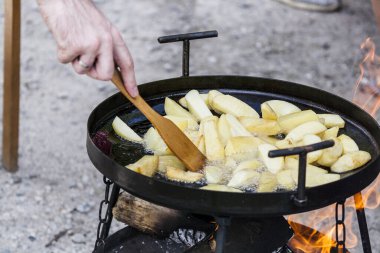 Cooking potatoes on the grill on a close-up, cooking food on a fire