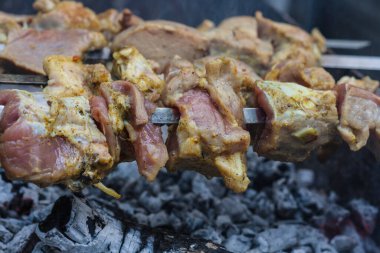 Cooking meat on skewers on the grill close-up. Pork meat in spices at the stake