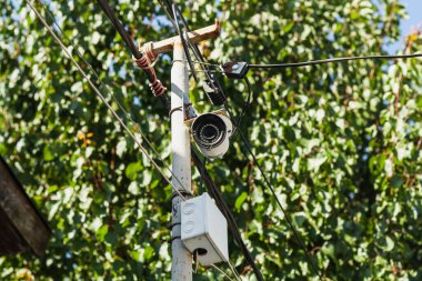 Hidden white surveillance camera, camouflaged outdoor surveillance camera