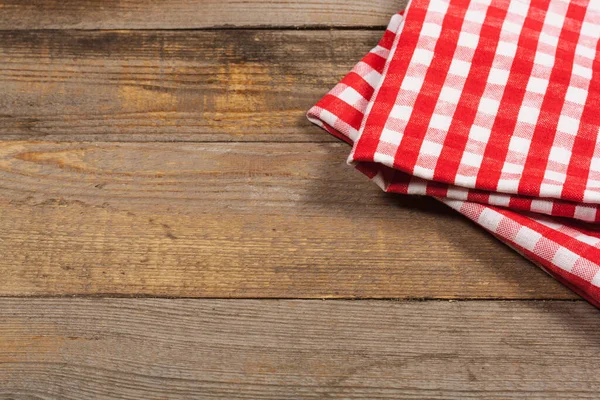 Wooden table and kitchen towel. View from above. Culinary concept. Background for cooking recipes