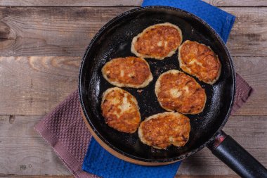 Fried chicken cutlets on a black frying pan close-up, fried meat products, home cooking