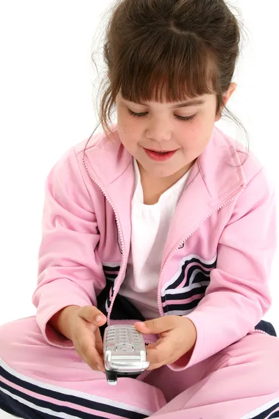 Krásná pět let stará dívka v růžových cvičební úbor s cellph — Stock fotografie