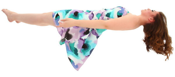 Beautiful teen girl levitating over white background.