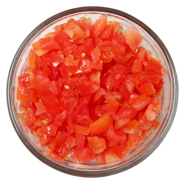 Cuenco de vidrio de tomates cortados en cubitos con vista superior sobre blanco — Foto de Stock