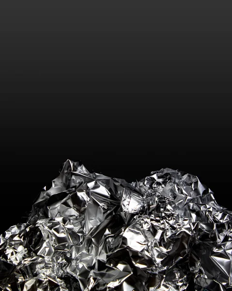 crumpled foil on black background