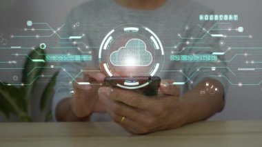 Bulut hesaplama hologramına bağlanmak için akıllı telefon kullanan bir adam. ticari dijital arkaplan.
