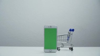 stop motion a cart shopping moving around smart phone green screen.